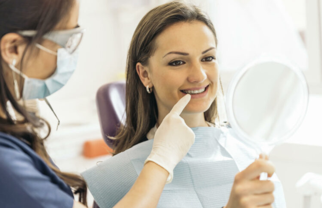 How should lower dentures fit?